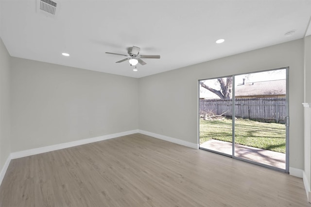 spare room featuring light hardwood / wood-style flooring and ceiling fan