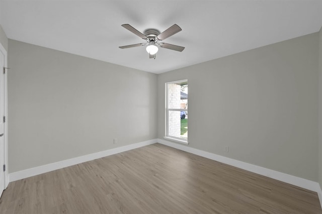 empty room with ceiling fan and light hardwood / wood-style floors