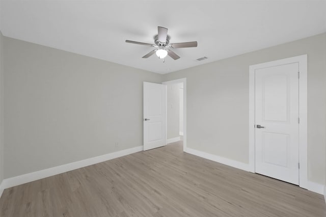 spare room featuring light hardwood / wood-style flooring and ceiling fan