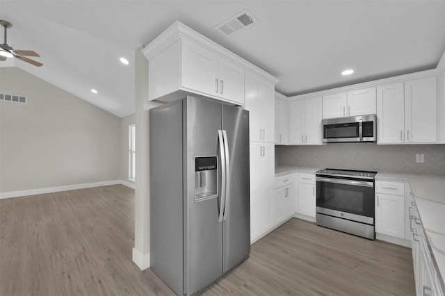 kitchen featuring white cabinets, backsplash, and stainless steel appliances