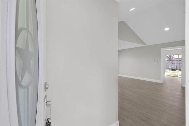 interior space featuring wood-type flooring and vaulted ceiling