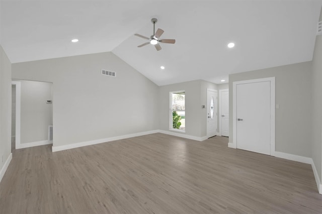 unfurnished living room featuring lofted ceiling, ceiling fan, and light wood-type flooring