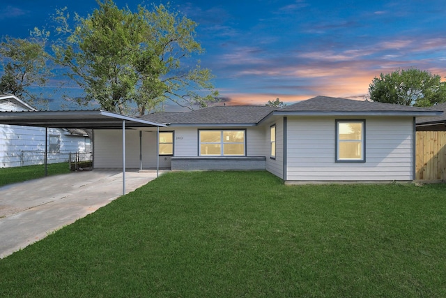 view of front of house featuring a lawn and a carport