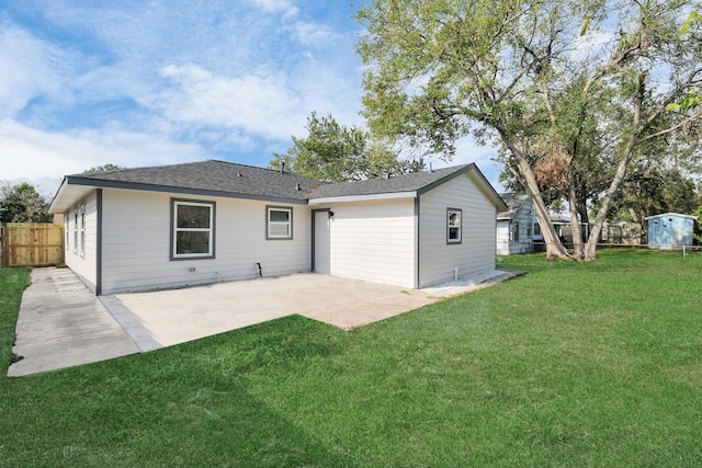 back of house featuring a yard and a patio