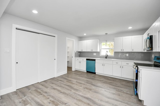 kitchen featuring electric stove, dishwasher, white cabinets, and hanging light fixtures