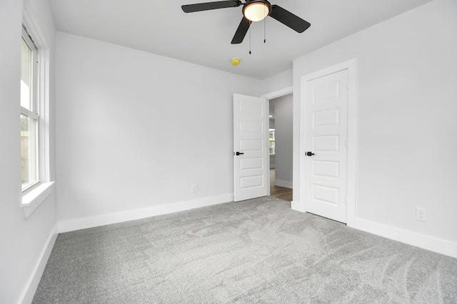 unfurnished bedroom featuring ceiling fan and light carpet