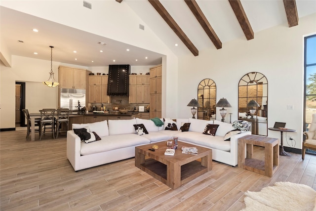 living room featuring beamed ceiling and high vaulted ceiling