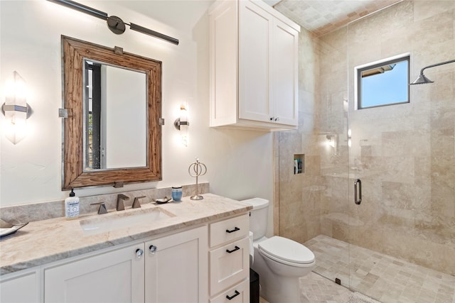 bathroom featuring vanity, an enclosed shower, and toilet