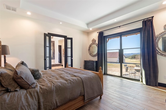 bedroom with access to exterior and light wood-type flooring