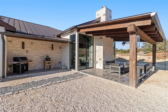 rear view of house with an outdoor living space and a patio area