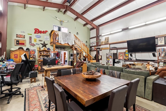 dining room with beamed ceiling and high vaulted ceiling