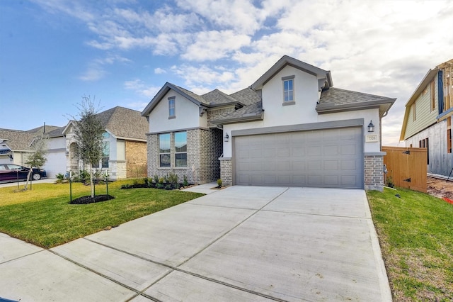 view of front of home with a garage and a front lawn