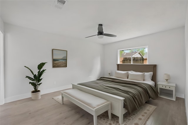 bedroom with ceiling fan and light hardwood / wood-style flooring