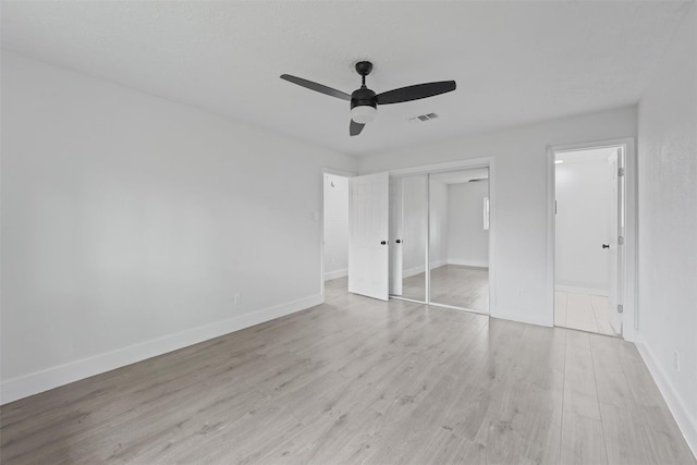 unfurnished bedroom with a closet, ceiling fan, and light hardwood / wood-style floors