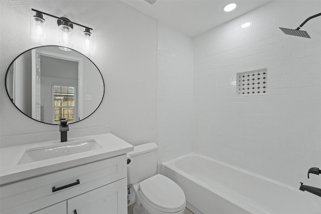 full bathroom featuring vanity, toilet, and tiled shower / bath combo