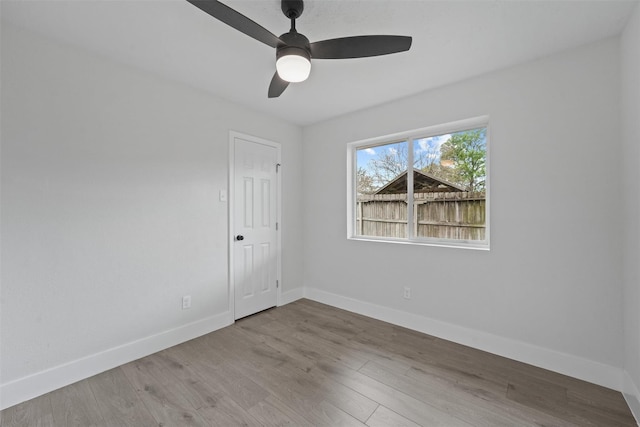 empty room with ceiling fan and light wood-type flooring