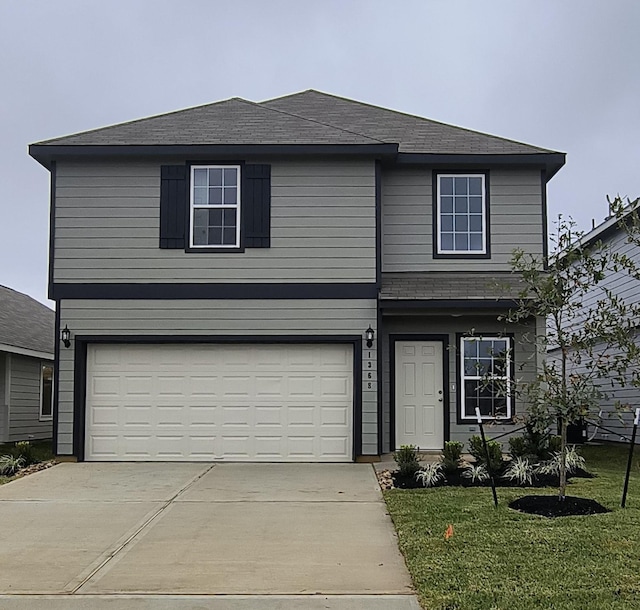 front of property with a front lawn and a garage