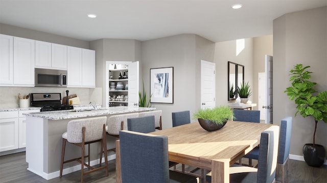 dining space with dark hardwood / wood-style flooring and sink