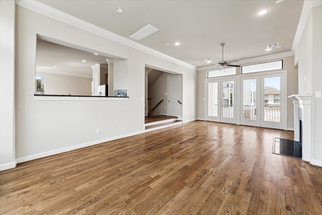 unfurnished living room featuring hardwood / wood-style floors, ceiling fan, ornamental molding, and french doors