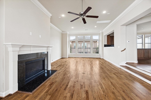 unfurnished living room with hardwood / wood-style floors, ceiling fan, and ornamental molding