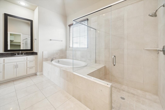 bathroom with tile patterned flooring, vanity, lofted ceiling, and shower with separate bathtub