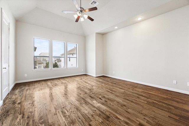 empty room featuring dark wood-type flooring, lofted ceiling, visible vents, and baseboards