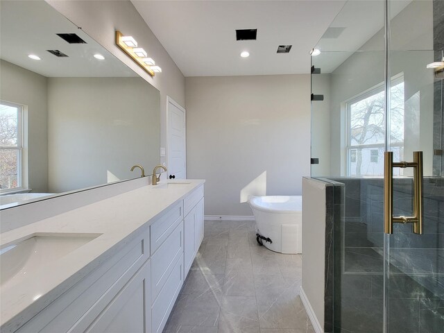 bathroom featuring vanity and shower with separate bathtub