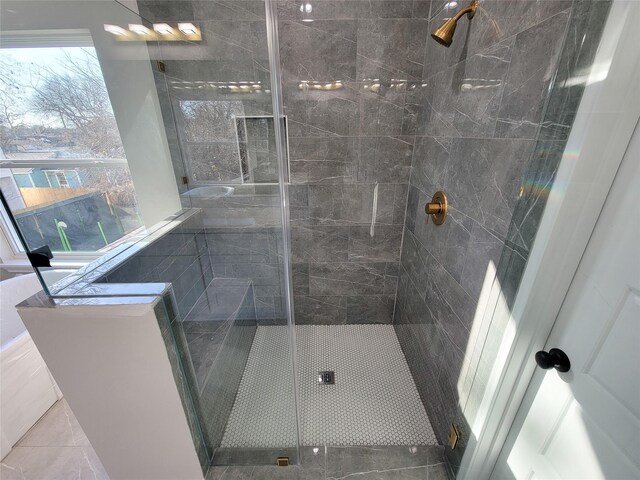 bathroom featuring a shower with shower door