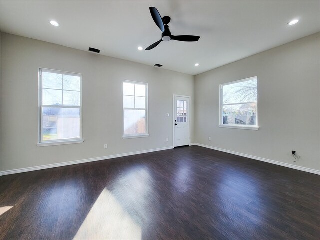 unfurnished room with dark hardwood / wood-style flooring and ceiling fan