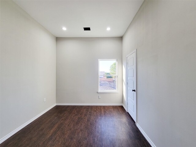 spare room with dark hardwood / wood-style flooring