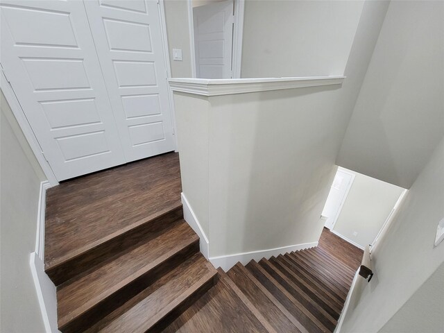 stairs featuring wood-type flooring