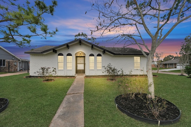 view of front of property with a lawn