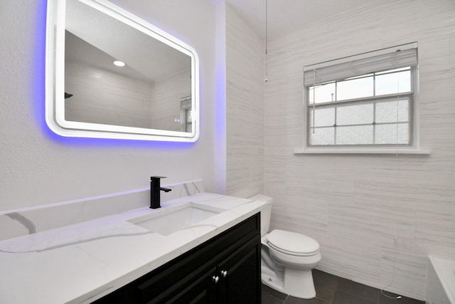 bathroom with tile patterned floors, vanity, and toilet