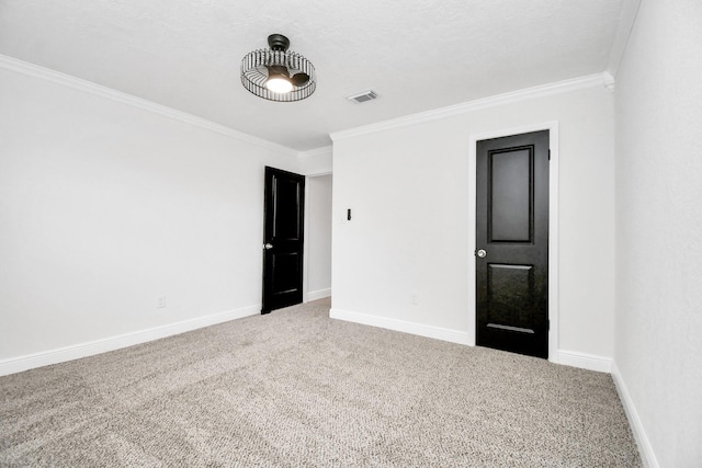 spare room featuring carpet flooring and crown molding