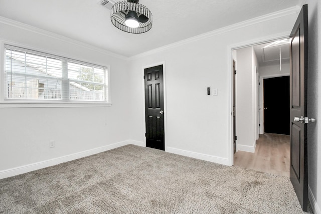 interior space featuring crown molding and light carpet