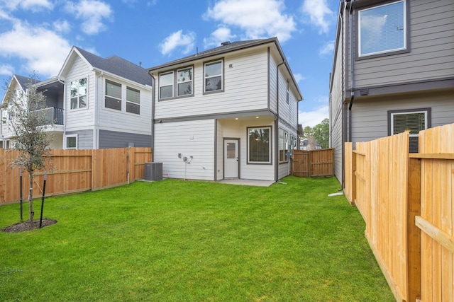 back of house with a lawn and central AC