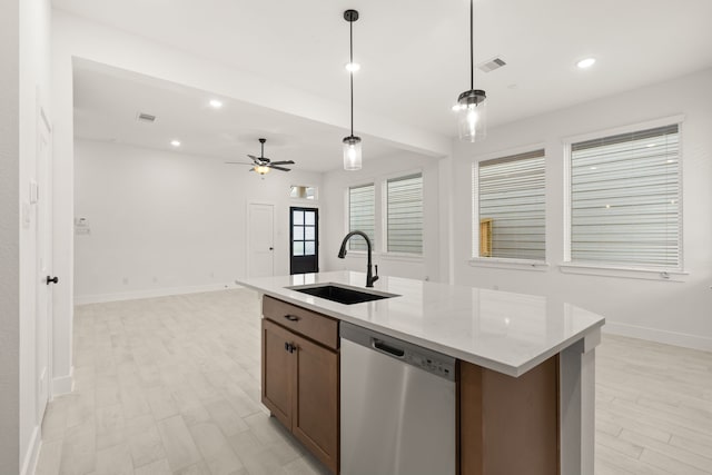 kitchen with light stone countertops, ceiling fan, sink, stainless steel dishwasher, and pendant lighting