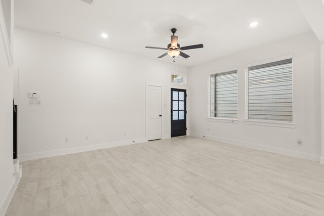 spare room with light hardwood / wood-style floors and ceiling fan