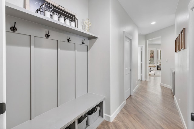 mudroom with light hardwood / wood-style flooring