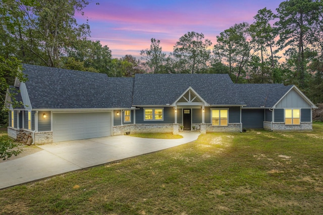 view of front of property with a garage and a lawn