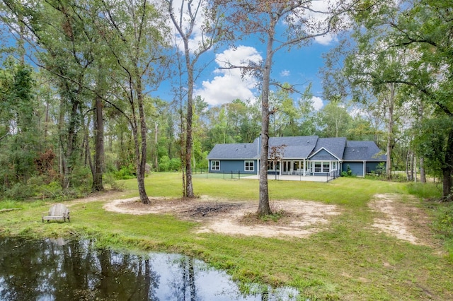 exterior space with a yard and a water view