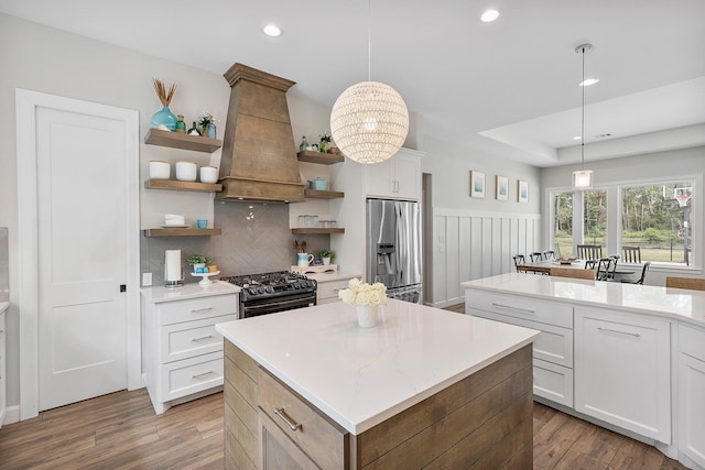 kitchen featuring stainless steel fridge with ice dispenser, white cabinetry, and pendant lighting