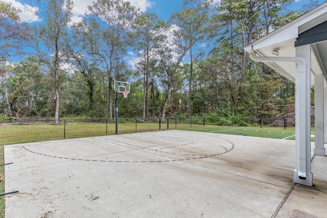 view of basketball court with a yard