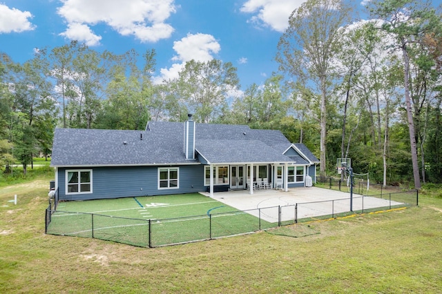 rear view of property with a yard and a patio