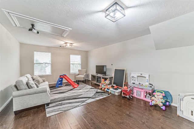 rec room featuring dark hardwood / wood-style flooring and a textured ceiling