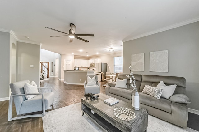 living room featuring crown molding, hardwood / wood-style floors, and ceiling fan