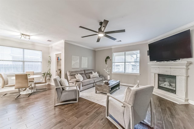 living room with crown molding, ceiling fan, and hardwood / wood-style flooring