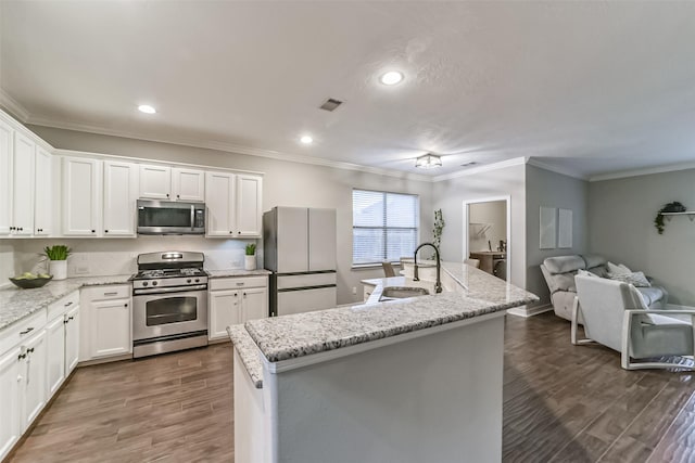 kitchen featuring a center island with sink, white cabinetry, sink, and appliances with stainless steel finishes