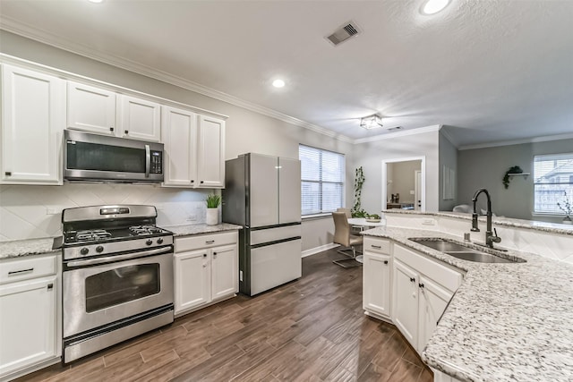 kitchen featuring light stone counters, sink, white cabinetry, and stainless steel appliances