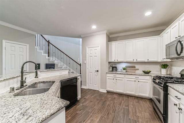 kitchen featuring light stone counters, stainless steel gas range, sink, dishwasher, and white cabinetry